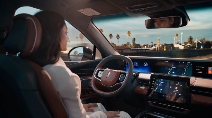 A person is shown driving hands-free on the highway with available Lincoln BlueCruise technology. | Holmes Tuttle Lincoln in Tucson AZ