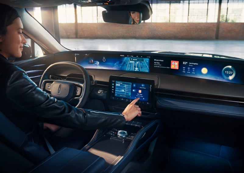 The driver of a 2024 Lincoln Nautilus® SUV interacts with the center touchscreen. | Holmes Tuttle Lincoln in Tucson AZ