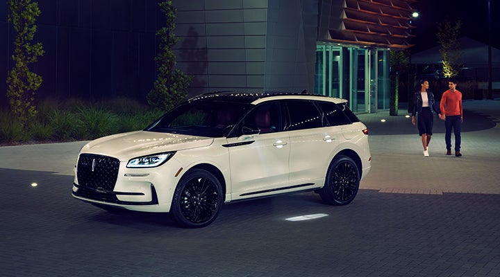 Two people approach a 2024 Lincoln Corsair® SUV featuring the available Jet Appearance Package. | Holmes Tuttle Lincoln in Tucson AZ