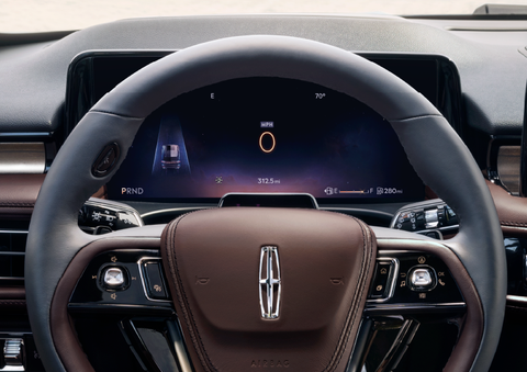 The steering wheel of 2025 Lincoln Aviator® SUV is shown with black and brown accents. | Holmes Tuttle Lincoln in Tucson AZ