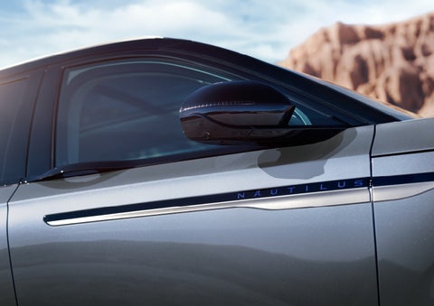 Blue lettering on the side of the vehicle that reads nautilus indicates the available hybrid powertrain. | Holmes Tuttle Lincoln in Tucson AZ