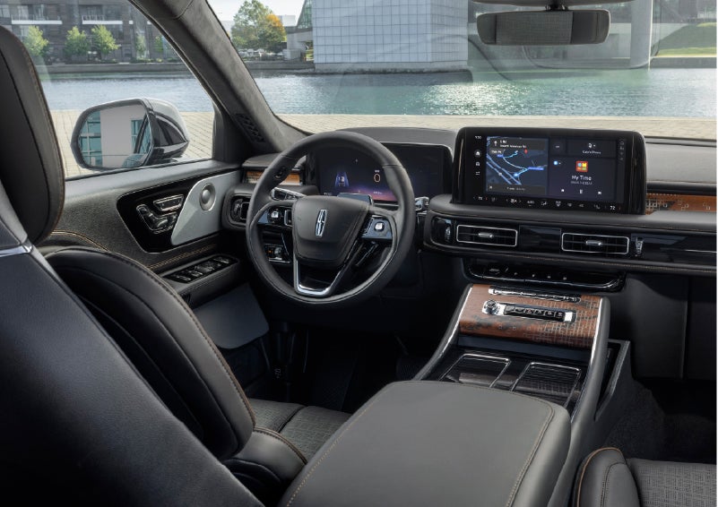 The interior of the 2026 Lincoln Aviator® SUV is shown parked with a view of a harbor through the windshield. | Holmes Tuttle Lincoln in Tucson AZ