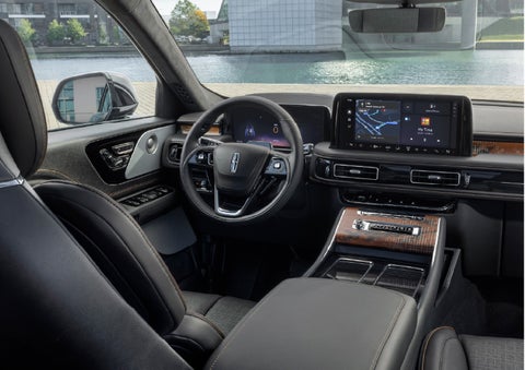 The interior of the 2026 Lincoln Aviator® SUV is shown parked with a view of a harbor through the windshield. | Holmes Tuttle Lincoln in Tucson AZ