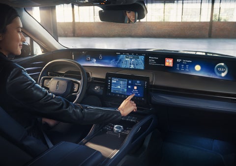 The driver of a 2026 Lincoln Nautilus® SUV interacts with the center touchscreen. | Holmes Tuttle Lincoln in Tucson AZ