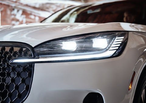 A close-up of a headlamp on the 2027 Lincoln Aviator® SUV is shown. | Holmes Tuttle Lincoln in Tucson AZ