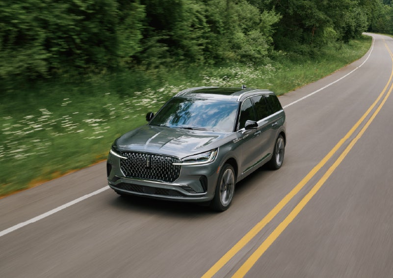 A 2027 Lincoln Aviator® SUV is being driven down a road. | Holmes Tuttle Lincoln in Tucson AZ