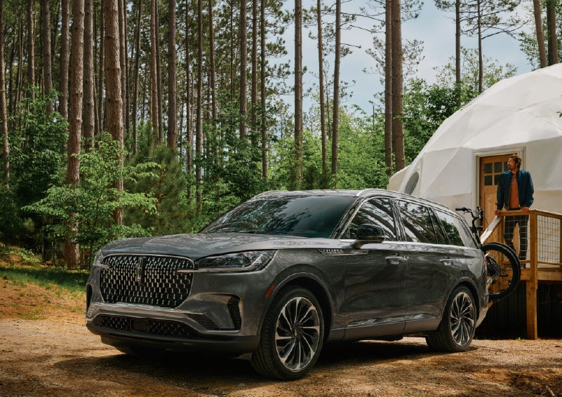 A 2027 Lincoln Aviator® is parked next to a high end glamping site. | Holmes Tuttle Lincoln in Tucson AZ