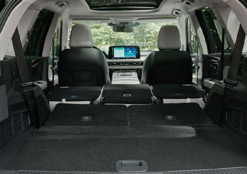 A rear to front view of the interior of a 2027 Lincoln Aviator® Black Label™ SUV shows the third and second rows folded flat | Holmes Tuttle Lincoln in Tucson AZ